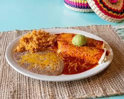 Enchiladas smothered in red sauce and cheese with rice and beans